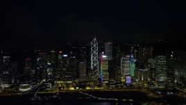 5K stock footage aerial video of tall Hong Kong Island skyscrapers seen from Victoria Harbor at nighttime, China Aerial Stock Footage | SS01_0188
