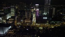 5K stock footage aerial video approach skyscrapers and office buildings on Nathan Road at night in Kowloon, Hong Kong, China Aerial Stock Footage | SS01_0190