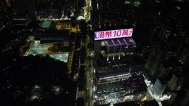 5K stock footage aerial video fly over Nathan Road past office buildings and Kowloon Park at night in Hong Kong Aerial Stock Footage | SS01_0193