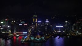 5K stock footage aerial video of approaching convention center and Central Plaza from harbor at night on Hong Kong Island, China Aerial Stock Footage | SS01_0203