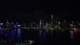 5K stock footage aerial video approach Hong Kong Island skyline from Kowloon at night, China Aerial Stock Footage | SS01_0216