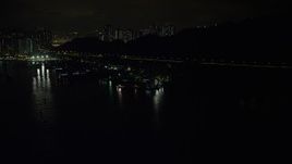 5K stock footage aerial video approach poorly lit piers and warehouses on Rambler Channel at night in Hong Kong, China Aerial Stock Footage | SS01_0251