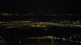 5K stock footage aerial video of airliners parked at the terminal at Hong Kong International Airport at night, China Aerial Stock Footage | SS01_0279