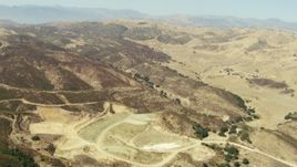 1080 stock footage aerial video of flying over barren hills and valleys in Simi Valley, California Aerial Stock Footage | TS01_011