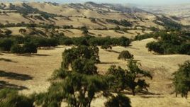 1080 stock footage aerial video of flying over mountain to reveal rolling hills and trees, Central California Aerial Stock Footage | TS01_111