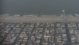 4K stock footage aerial video fly over homes, Manhattan Beach Pier, and the Pacific Ocean, California Aerial Stock Footage | WA001_002