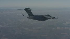 4K stock footage aerial video track a Boeing C-17 as it flies ahead over Solano County, California Aerial Stock Footage | WA001_041