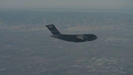 4K stock footage aerial video zoom in on a Boeing C-17 flying over Solano County, California Aerial Stock Footage | WA001_043