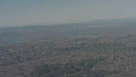 4K stock footage aerial video air-to-air view of a jet flying near Suisun Bay and windmills in Solano County, California Aerial Stock Footage | WA001_050