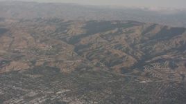 4K stock footage aerial video fly over suburban homes to approach Highway 118 and the mountains, Chatsworth, California Aerial Stock Footage | WA002_004