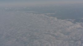4K stock footage aerial video tilt to the edge of a dense layer of clouds over Central Valley, California Aerial Stock Footage | WA002_024
