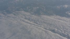 4K stock footage aerial video pan across Sierra Nevada Mountains and a dense layer of clouds, California Aerial Stock Footage | WA002_037