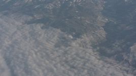 4K stock footage aerial video of the edge of cloud layer beside Sierra Nevada Mountains, California Aerial Stock Footage | WA002_041