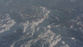 4K stock footage aerial video of a reverse view of snowy mountain ridges in the Sierra Nevada Mountains, California Aerial Stock Footage | WA002_054