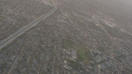 4K stock footage aerial video pan across neighborhoods to reveal I-105 with heavy traffic in Lynwood, California Aerial Stock Footage | WA003_024