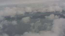 4K stock footage aerial video fly over clouds to reveal Puget Sound, Washington Aerial Stock Footage | WA004_037
