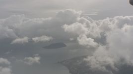 4K stock footage aerial video flyby white clouds over a small island in Puget Sound in Washington Aerial Stock Footage | WA004_038
