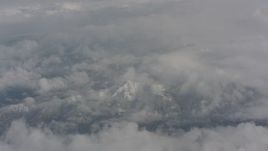 4K stock footage aerial video of snow-capped mountains beneath the clouds over Washington Aerial Stock Footage | WA004_066