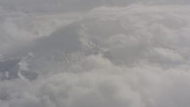 4K stock footage aerial video fly over clouds to approach Mount St. Helens with snow in Washington Aerial Stock Footage | WA004_074