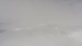 4K stock footage aerial video flyby a snowy mountain peak partially shrouded in clouds, Washington Aerial Stock Footage | WA004_084