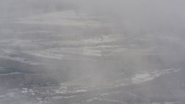 4K stock footage aerial video of a reverse view of snowy wilderness and misty clouds in Oregon Aerial Stock Footage | WA004_099
