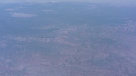 4K stock footage aerial video tilt from desert mountains to reveal mesas and a distant peak in Arizona Aerial Stock Footage | WA007_027