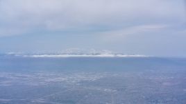 4K stock footage aerial video of the San Gabriel Mountains with snow seen from Riverside, California Aerial Stock Footage | WA007_040