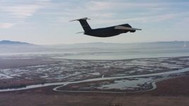 4K stock footage aerial video of a Lockheed C-5 flying over marshland in Northern California Aerial Stock Footage | WAAF01_C004_0117UU