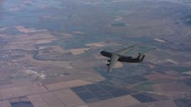 4K stock footage aerial video of tracking a Lockheed C-5 jet flying over farmland in Northern California Aerial Stock Footage | WAAF01_C017_011717
