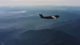 4K stock footage aerial video of a Lockheed C-5 flying over mountains in Northern California Aerial Stock Footage | WAAF01_C027_0117SH