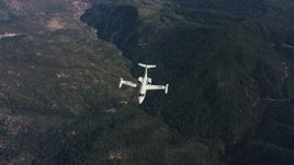 4K stock footage aerial video of a reverse view of mountains, revealing a Learjet C-21 in flight over Northern California  Aerial Stock Footage | WAAF02_C019_0117JN