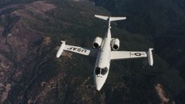 4K stock footage aerial video of a reverse view of a Learjet C-21 flying over mountains in Northern California Aerial Stock Footage | WAAF02_C019_0117JN_S000