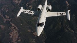 4K stock footage aerial video of a Learjet C-21 flying in and out of frame over mountains in Northern California Aerial Stock Footage | WAAF02_C019_0117JN_S001