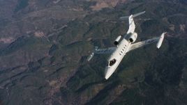 4K stock footage aerial video of a Learjet C-21 flying from side to side over mountains in Northern California Aerial Stock Footage | WAAF02_C019_0117JN_S002