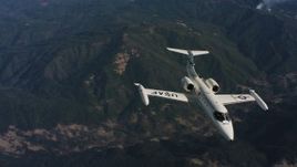 4K aerial stock footage video of tracking a Learjet C-21 in flight over mountains in Northern California Aerial Stock Footage | WAAF02_C020_0117TR