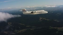 4K stock footage aerial video of a Learjet C-21 in the air over mountains in Northern California Aerial Stock Footage | WAAF02_C031_01177D