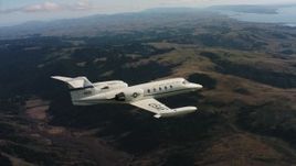 4K stock footage aerial video of a Learjet C-21 flying above mountains in Northern California Aerial Stock Footage | WAAF02_C032_0117R3