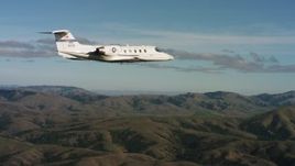 4K stock footage aerial video of a Learjet C-21 flying near hills in Northern California Aerial Stock Footage | WAAF02_C042_0117T2