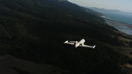 4K stock footage aerial video of a Learjet C-21 flying over coastal hills in Northern California Aerial Stock Footage | WAAF02_C047_0117D7