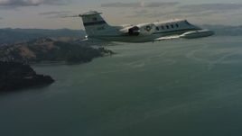 4K stock footage aerial video of a Learjet C-21 flying over the bay, Northern California Aerial Stock Footage | WAAF02_C054_0117PF