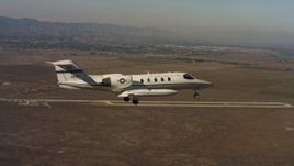 4K stock footage aerial video of a Learjet C-21 flying near Travis Air Force Base, California Aerial Stock Footage | WAAF02_C065_0117R0