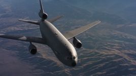 4K stock footage aerial video of flying by a McDonnell Douglas KC-10 in flight over hills and farms in Northern California Aerial Stock Footage | WAAF03_C014_01184M