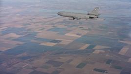 4K stock footage aerial video of flying around the tail of a McDonnell Douglas KC-10 over farmland in Northern California Aerial Stock Footage | WAAF03_C015_01181L