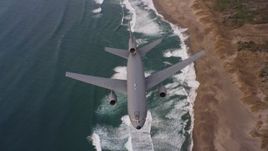 4K stock footage aerial video of a reverse view of a McDonnell Douglas KC-10 flying over beaches in Northern California Aerial Stock Footage | WAAF03_C055_01189Q