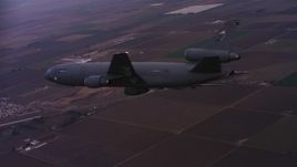 4K stock footage aerial video of a McDonnell Douglas KC-10 in flight over farmland at sunset in Northern California Aerial Stock Footage | WAAF03_C070_0118QG