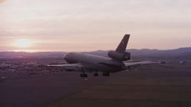 4K stock footage aerial video of a McDonnell Douglas KC-10 approaching Travis Air Force Base at sunset, California Aerial Stock Footage | WAAF03_C074_0118AU