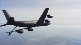 4K stock footage aerial video of a Boeing KC-135 flying over farmland and out of frame, Northern California Aerial Stock Footage | WAAF04_C032_0118WT