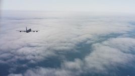 4K aerial stock footage video of a Boeing KC-135 flying over low coastal clouds in Northern California Aerial Stock Footage | WAAF04_C069_011863_S000