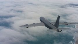 4K stock footage aerial video of a Boeing KC-135 flying over clouds on the coast in Northern California Aerial Stock Footage | WAAF04_C070_0118HE_S000