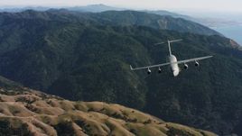 4K stock footage aerial video of a reverse view of a Boeing C-17 over mountains in Northern California Aerial Stock Footage | WAAF05_C035_0118SM